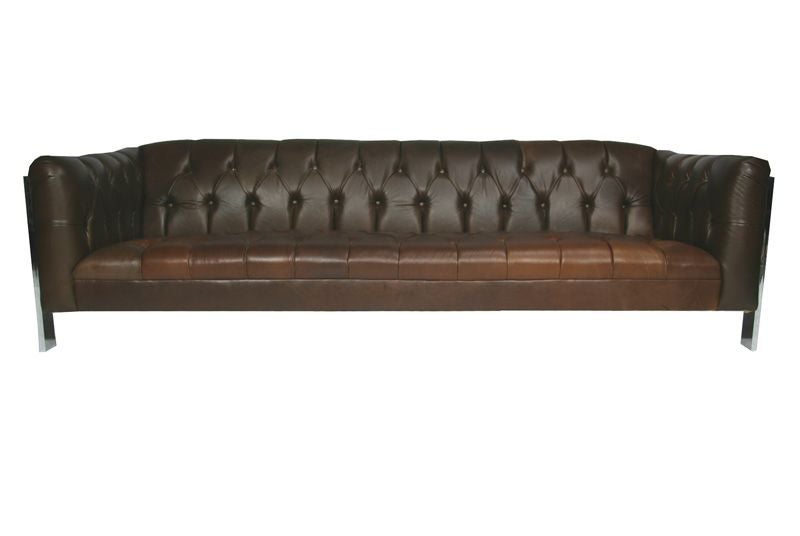 Button tufted brown leather sofa with chrome frame sides designed by Milo Baughman. Seat depth: 22.5 inches