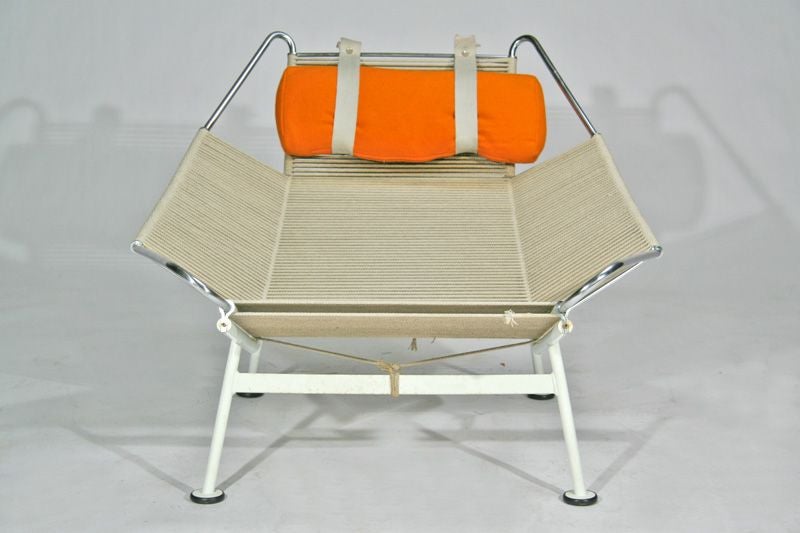 Pair of lounge chairs designed by Hans Wegner for Getama, with matching orange wool cushions.  A lambskin or sheepskin throw can also be used on top of the flag-halyard seat.  Seat Depth: 18