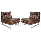 Pair of leather lounge chairs with chrome bases