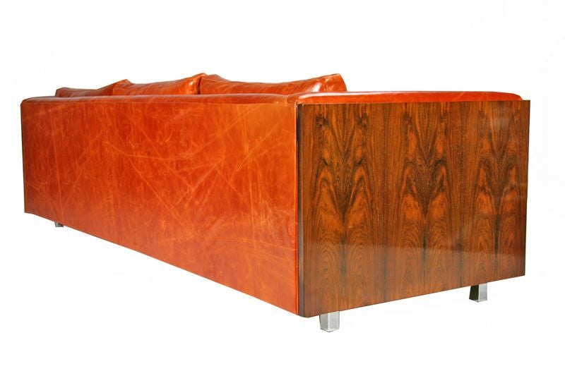 Rosewood-sided case sofa with square chrome legs and leather designed by Milo Baughman for Thayer-Coggin. The sofa is newly upholstered in a vibrant distressed orange leather. Seat Depth: 22