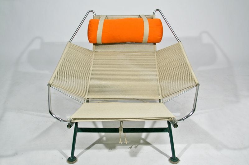 Lounge chair designed by Hans Wegner for Getama, with green enamel finish to the metal. A lambskin or sheepskin throw can also be used on top of the flag-halyard seat. Seat Depth: 18