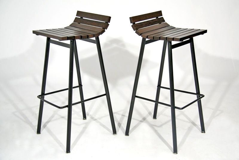 Bar stools with black powder coated steel bases and solid Wenge slats. Available in custom finishes. Price below is per stool, 6 stools available in this African Wenge. Seat Depth: 11