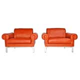 Burnt orange leather and steel arm chairs by Maison Jansen