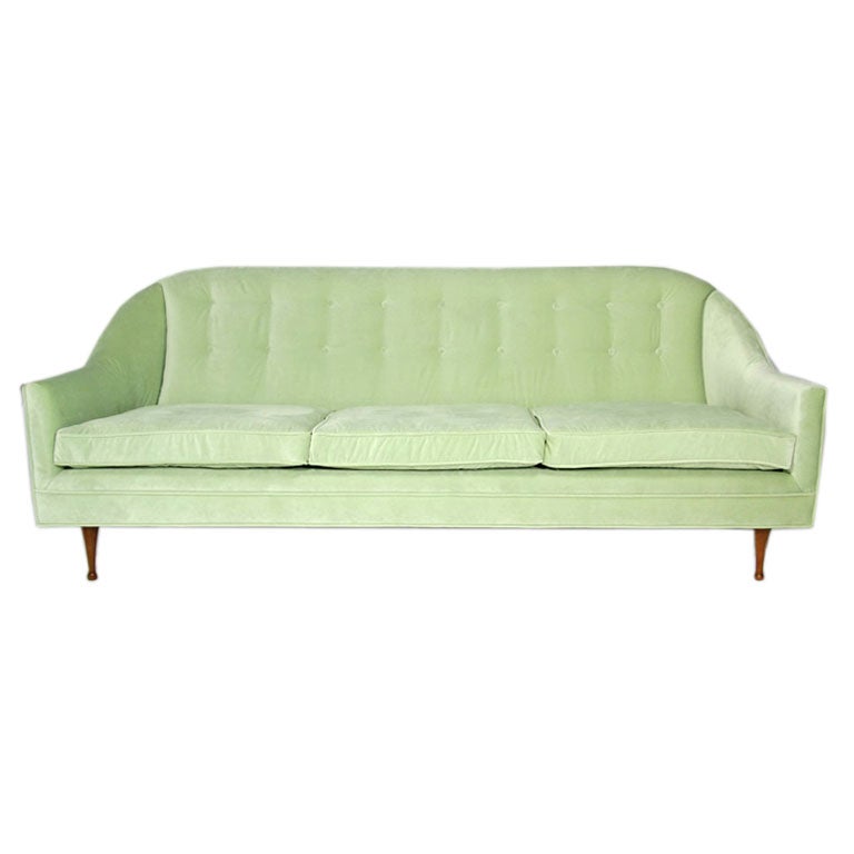 A celery velvet curved sofa by Paul McCobb