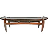 Solid rosewood coffee table with arched top by Jean Gillon
