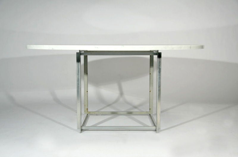 The PK 54 table was made for dining or conference use and is composed of six squares of matte chrome steel that a intermeshed to form a solid base for the white marble top.  Stamped with E. Kold Christiansen mark.<br />
<br />
Marble is 1 3/8
