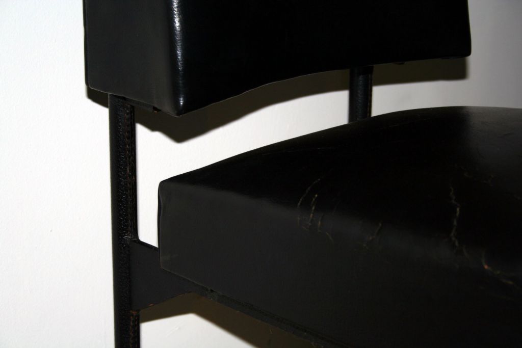 Set of six chairs in original black leather with black enameled metal legs.