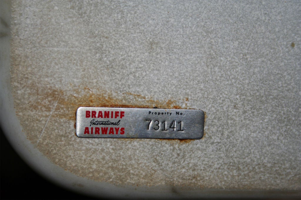 Pair of marble top end tables with aluminum base; designed in 1965 for Braniff Airways, and in production by Herman Miller for one year. These tables maintain their original Braniff Airways property labels.