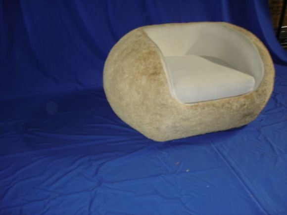 An unusual chair crafted from natural rafia husk to create a chair in the same manner of Jean Royere's 
