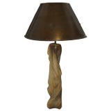 An organically sculpted table lamp with solid brass shade