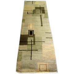 A MODERNIST GEOMETRIC PATTERNED RUNNER RUG