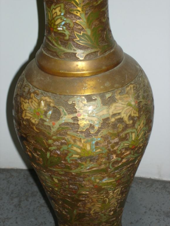 A unique pair of table lamps with a cloisonne type of relief on a bronze base metal. Intricately incised Asian motifs in the manner of Laverne and Mastercraft.<br />
<br />
These lamps are presently warehoused in Los Angeles.