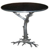 Granite top table with metal gnarled tree root base