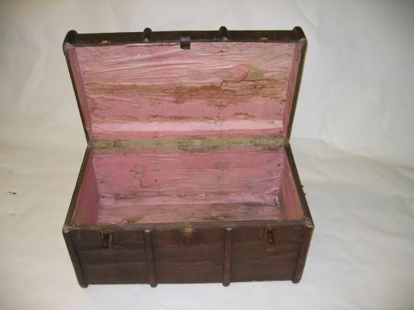A Wood banded canvas covered steamer trunk with linen interior