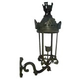 An Outdoor Iron Lantern with unique castle-shaped crown