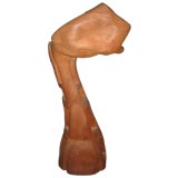 A large wooden sculpture of an arm/ abstracted at another angle