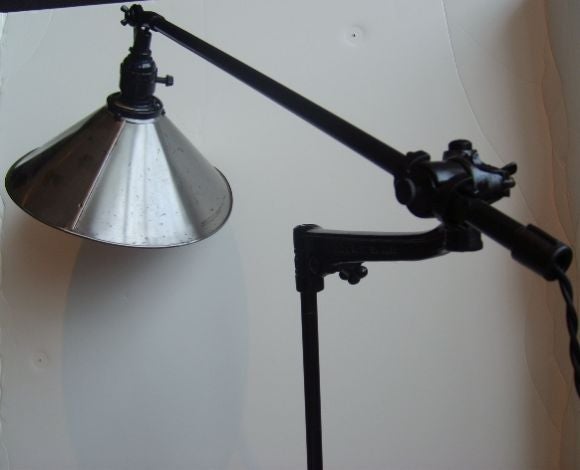 A Factory Light with black arm and polished steel shade
