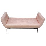 A Mid-Century bench with winged ends and tufted seat