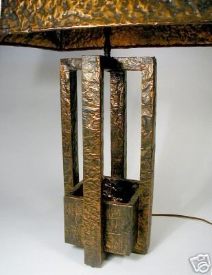 An unusual hammered copper lamp with excellent patina with four center set risers meeting to support a matching shade. Designed by Edward J. Pullman for New Life Studios circa 1947. <br />
Special thanks to Chris at DESIGNbase for the attribution.