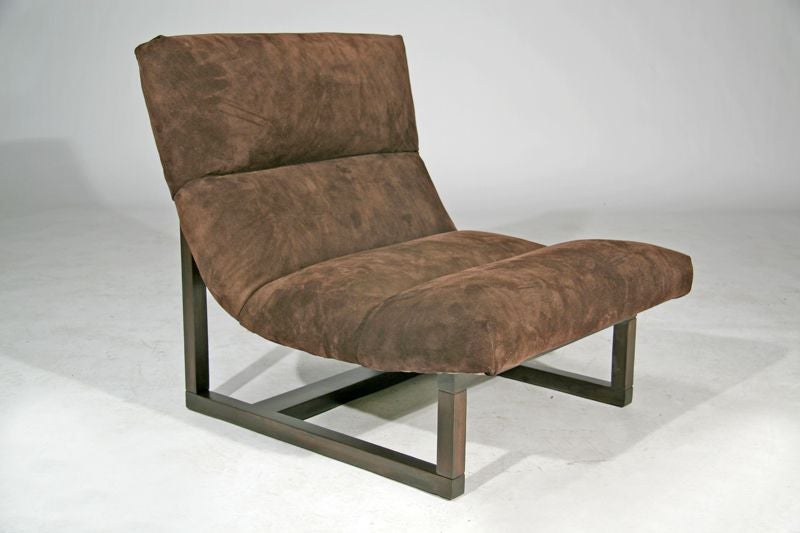 A pair of scoop chairs upholstered in suede by Milo Baugman with a wood base.