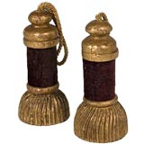 A PAIR OF CARVED GILTWOOD TASSELS WITH AGED MAROON VELVET