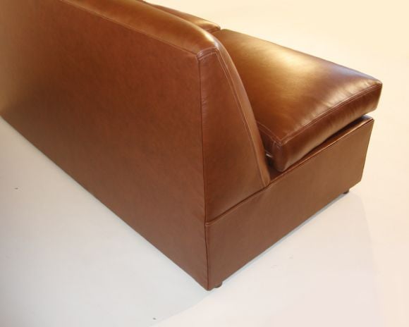 This armless sofa is surprising small to contain a full size sofa bed mechanism with room for pillow storage as well.  All premium vat dyed cowhide that is saddle stitched at seams.   The cushions are down wrapped foam cushions with another smaller