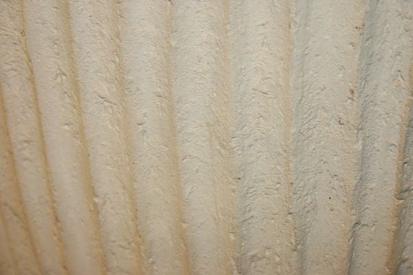 AN ITALIAN NEOCLASSICAL STYLE FLUTED URN WITH ANIMALS IN RELIEF