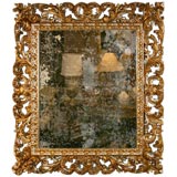 An intricately carved 18th  Century Italian Gilded Mirror .