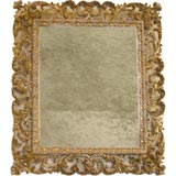 An intricately carved 18th Century Italian Gilded Mirror.