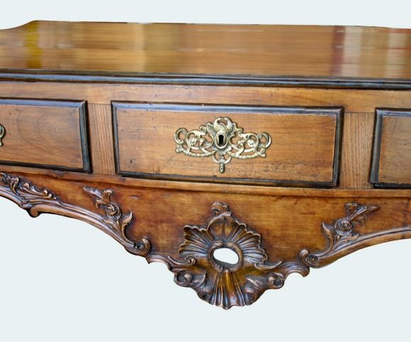 An eccentric Portugese rococo parcel ebonized library table