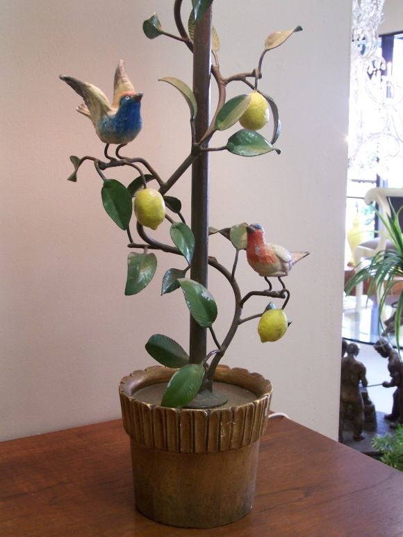 This beautiful tole lamp is adorned with delicate brids and leaves on a lemon tree in a pot.  It is a fun accent to any room.