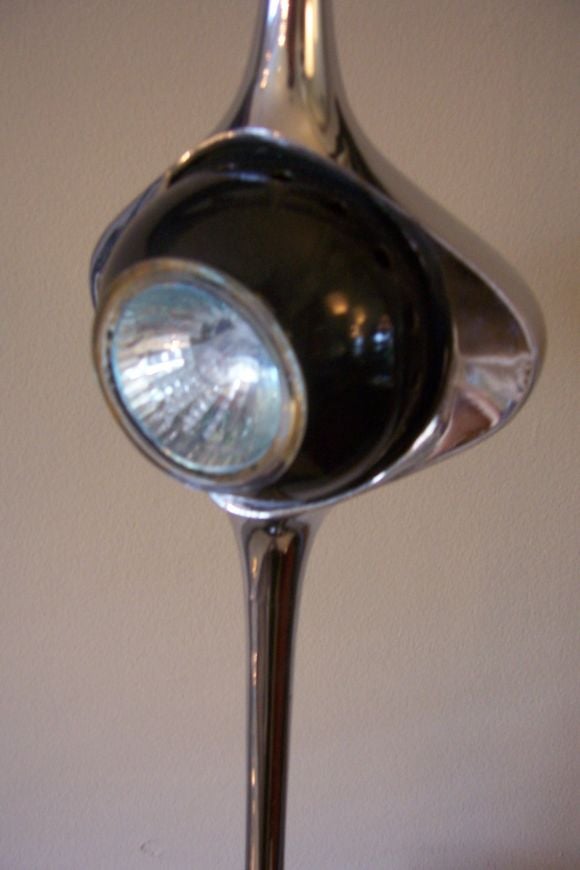 This modern Italian designed table lamp is reminiscent of a chromed cobra head.  The light is adjustable and it is a heavy piece.