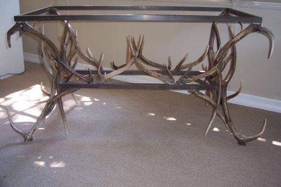 Anthony Redmile Finely constructed bronze deer antlers serve as the legs and base of this piece.  It will surely make a luxurious addition to any contemporary and eclectic decor.