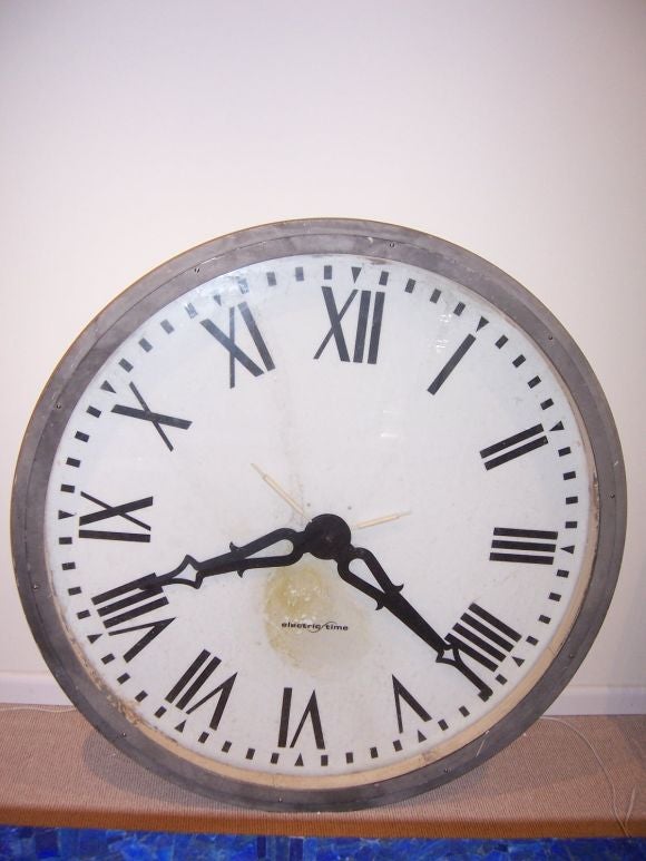 Large clock face and mechanism - probably works (not tested) with roman numeral hours.  Lucite backing can be illuminated - made of heavy metal, a GREAT piece.
