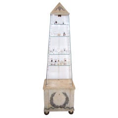 An Illuminated Obelisk Vitrine