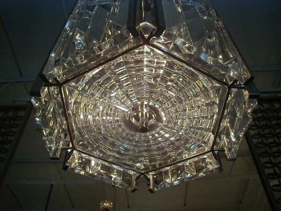 Signed Orrefors crystal chandelier done in accordion pleated panels of crystal set into a frame of nickeled bronze. Removed during a recent renovation of Washington DC's Kennedy Center for the Performing Arts. Originally installed in 1971, though