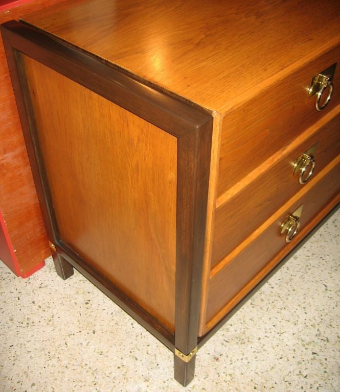 Beautifully refinished nine drawer dresser by Henredon, done in the asian style and dating to the 1960's. Extremely well made, this piece is realized in solid pecan wood with walnut support framing on the sides and base. Solid brass fittings. Signed