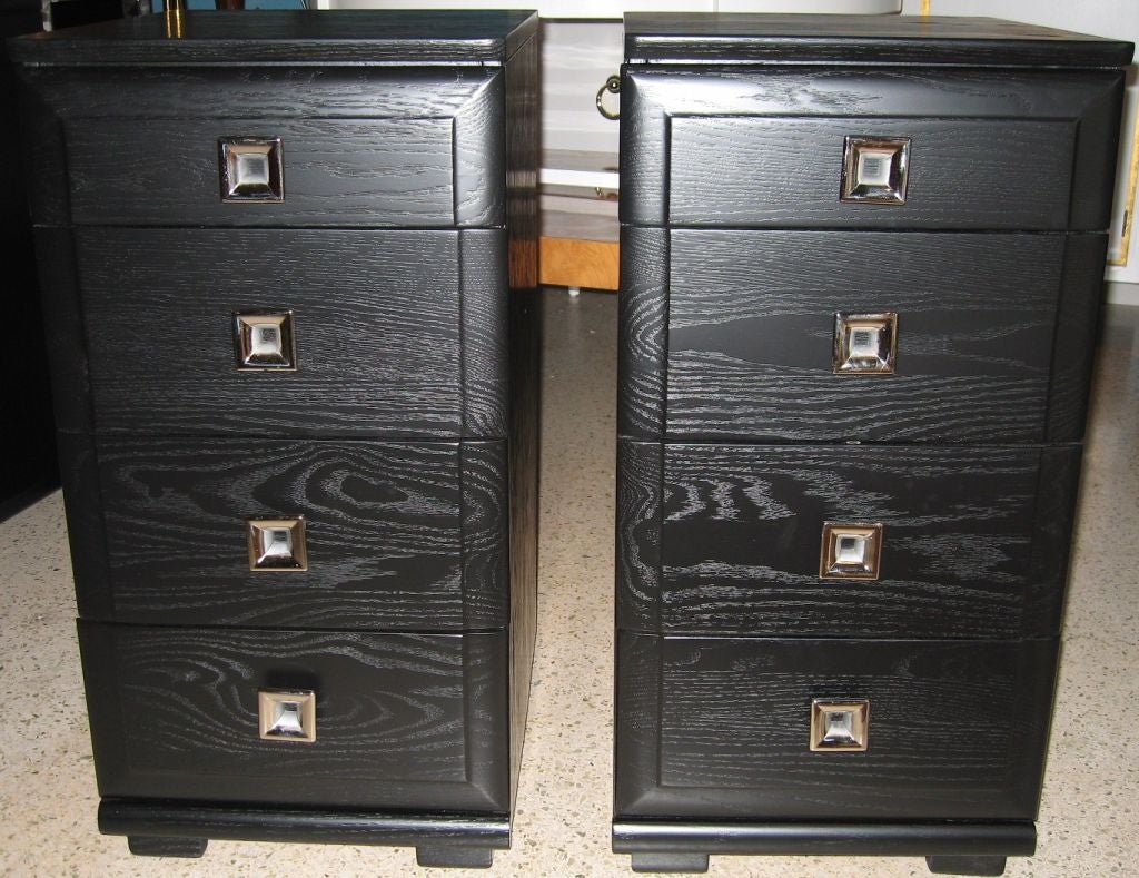 Post war late 1940's pair of raised grain ebonized night stands. Multiple drawers with square nickel hardware, drawer interiors are natural ash. Designed by the Mengel Furniture company. 24 HOUR HOLD ONLY