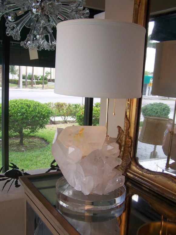These beautiful lamps are custom designed by Gustavo Olivieri.  They are large cluster of clear quartz on a round lucite base with custom shades.