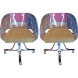 A Pair of Ribbon Framed Lucite Chairs on Casters