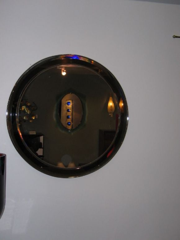 A Round Wall Mirror in a Chrome Frame