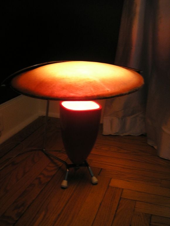 A modernist table lamp by Mitchell Bobrick for Controlight, Los Angeles California. The lamp features a chrome frame with a enameled ceramic up light shade and a round adjustible natural colored fiberglass diffuser. Bobrick designed a similar