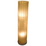 A Cellulose Ribbed Column Lamp on a Cork Base