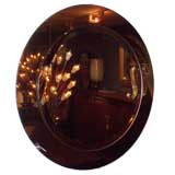 A Round Wall Mirror in the style of Fontana Arte