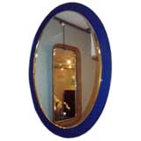 An Oval Wall Mirror in the style of Fontana Arte