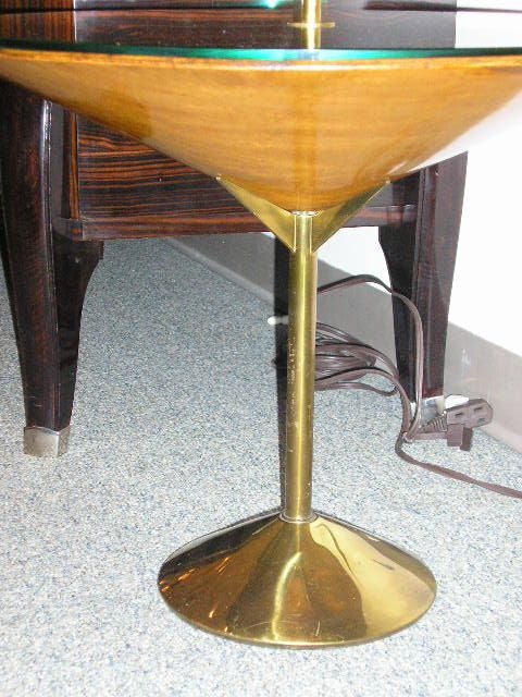 A occasional table featuring a body shaped like a martini glass with a brass base and stem as well as top handle, a molded wood bowl and a glass top. By Roberto Mango, Italy circa 1940.