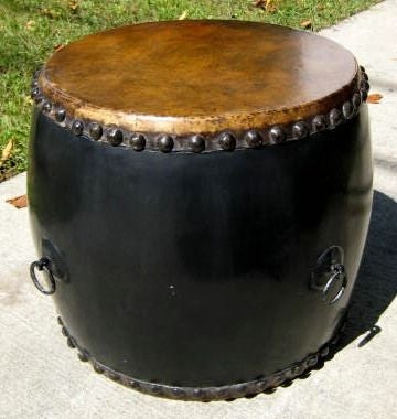 Drum table with a distressed leather top.<br />
Nail head accents. Side D rings. Two are available. 18D x 17H, 20D x 18H.
