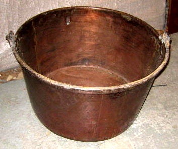 Hammered copper tub with handle. Great for firewood. Will also make a great planter.