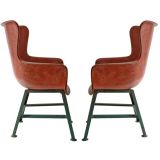 A Pair of Rose Colored Fiber Glass Chairs