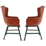 A Pair of Rose Colored Fiber Glass Chairs